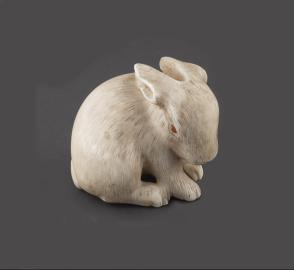 Netsuke modeled as a hare with amber eyes