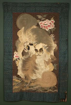 Embroidered wall hanging with lion-dog design