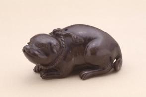 Waterdropper modelled as a reclining dog