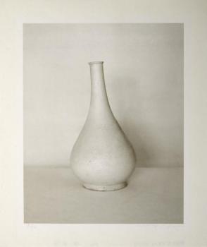 Photograph of long-necked white bottle  