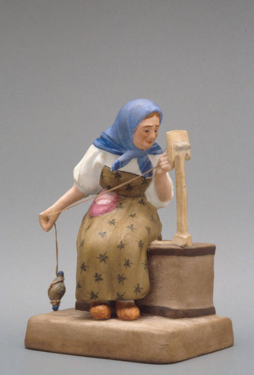 Figure of an old woman spinning