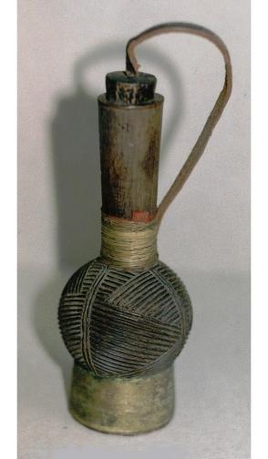 Snuff bottle with incised designs and attached stopper