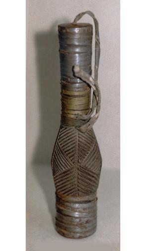 Snuff bottle with incised designs and attached stopper