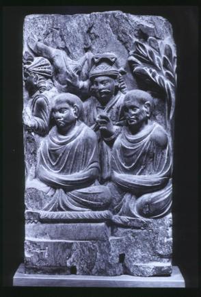 Two Buddhist monks and attendants