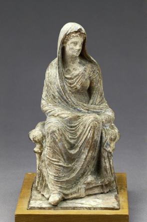 Seated tanagra figurine
