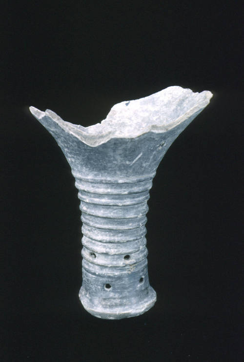 Black pottery shard; stem of vessel