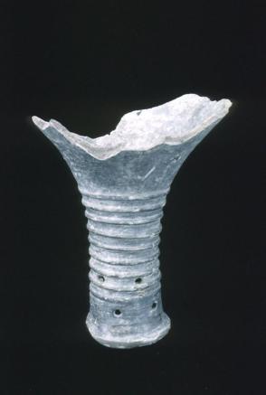 Black pottery shard; stem of vessel
