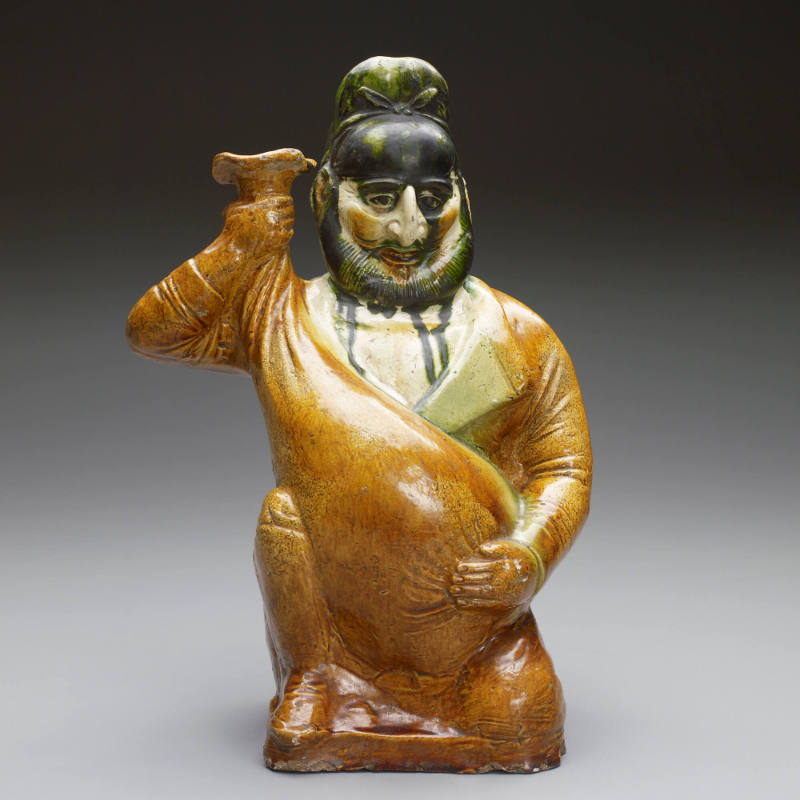 Figure of foreign merchant holding wine skin