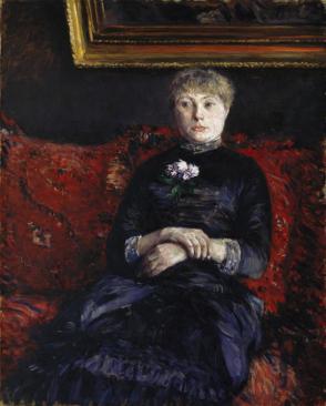 Woman Seated on a Red-Flowered Sofa