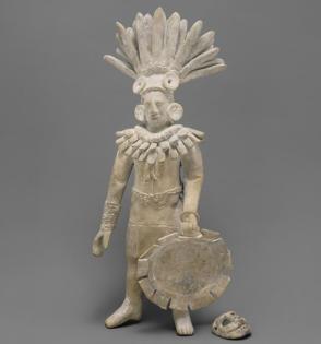 Warrior figure with mask and shield