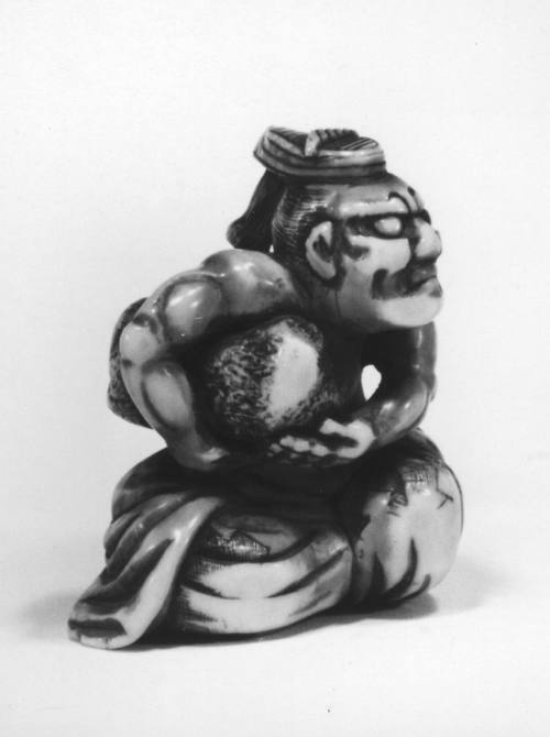 Man holding rock under his arm