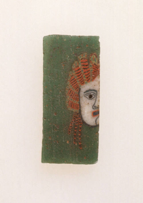 Tile with half of a theater mask