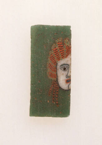 Tile with half of a theater mask