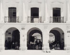 The market place—Where men are seldom seen. Here, tending bar as well as bargaining is woman’s work, and it is here that everything is bought and sold. Town of Juchitan, from Amero Picture Book