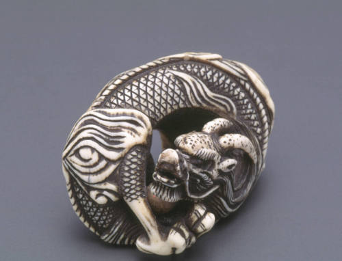 Netsuke modelled as a dragon with enclosed pearl