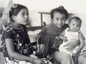 Happy children. They drink from the same glass, from Amero Picture Book