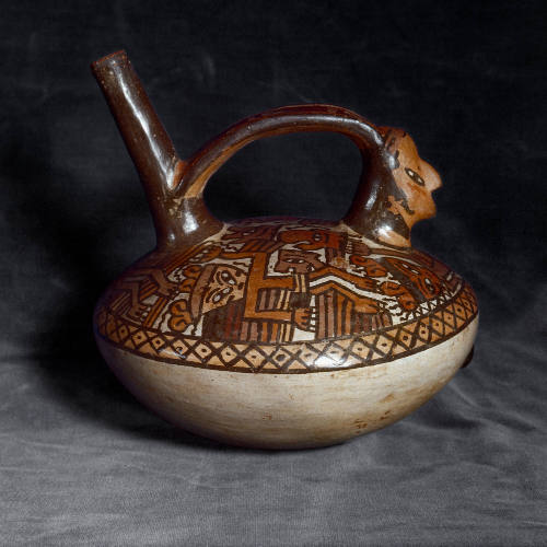 Whistling vessel:  falling figures, corpses and trophy heads