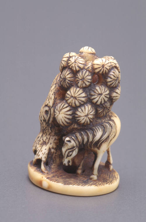 Netsuke modelled as a horse beneath a tree
