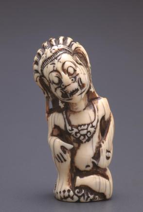 Netsuke modelled as a kris handle