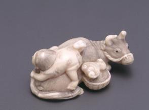 Netsuke modelled as a child astride a bull