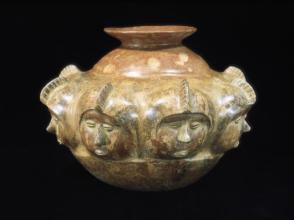 Vessel with eight human faces