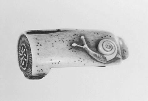 Leaf and snail on a tile