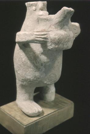 Human figure offering a vase