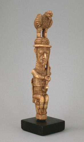 Seated Guardian Figure with Gun and Chicken on Hat