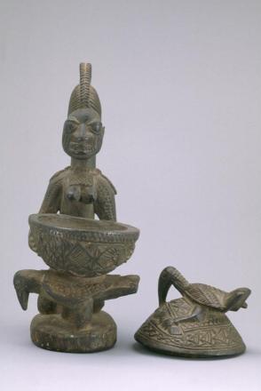 Kneeling woman with covered bowl for kola nuts:  (Olumeye)